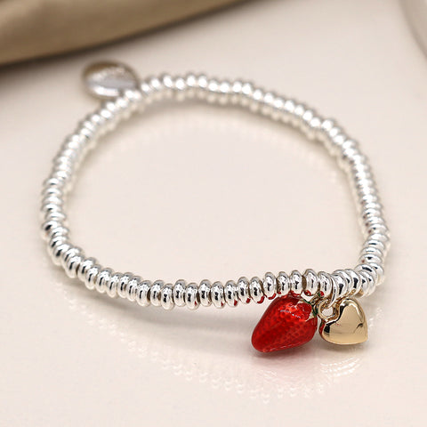Silver plated bead stretch bracelet with a red enamel strawberry and faux gold plated heart charm