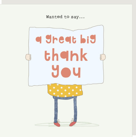 Big Thanks Greeting Card from Rosie Made a Thing - a square greeting card with a pebble envelope behind, featuring a hand-drawn illustration of a person holding a large white sign that reads 'a great big thank you.' The text at the top says 'Wanted to say.