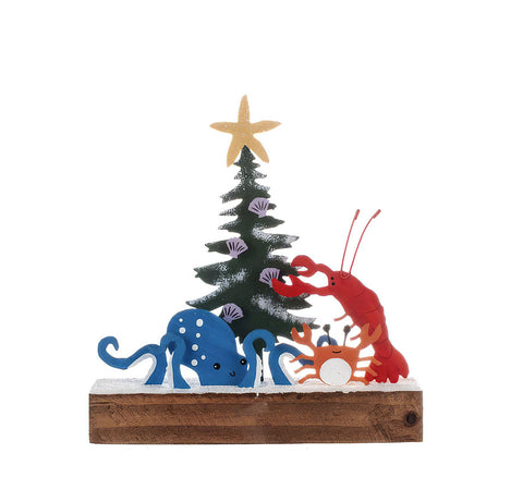 Shoeless Joe Lobster Dressing the Tree Christmas Decoration with a blue octopus and orange crab on a snow covered wooden plinth.