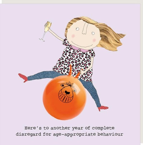 Disregard Greeting Card from Rosie Made a Thing featuring a whimsical illustration of a girl with blonde hair riding an orange ball with the text 'Here's to another year of complete disregard for age-appropriate behaviour'. 