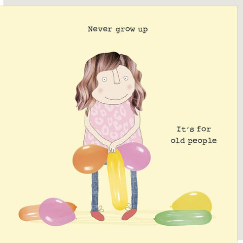 Never Grow Up Greeting Card from Rosie Made a Thing - a square greeting card with a pale yellow background, featuring a whimsical illustration of a woman with brown hair holding three colorful balloons in a suggestive combination, with the text 'Never grow up' at the top and 'It's for old people' on the right.