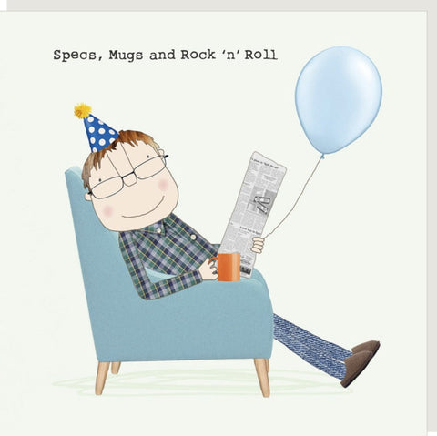 Men's birthday card from Rosie made a thing featuring  a whimsical illustrated man wearing a blue polka-dot party hat and glasses relaxes in a light blue armchair, holding a newspaper and an orange mug while holding the string of a light blue balloon. The text at the top reads, 'Specs, Mugs and Rock 'n' Roll'.